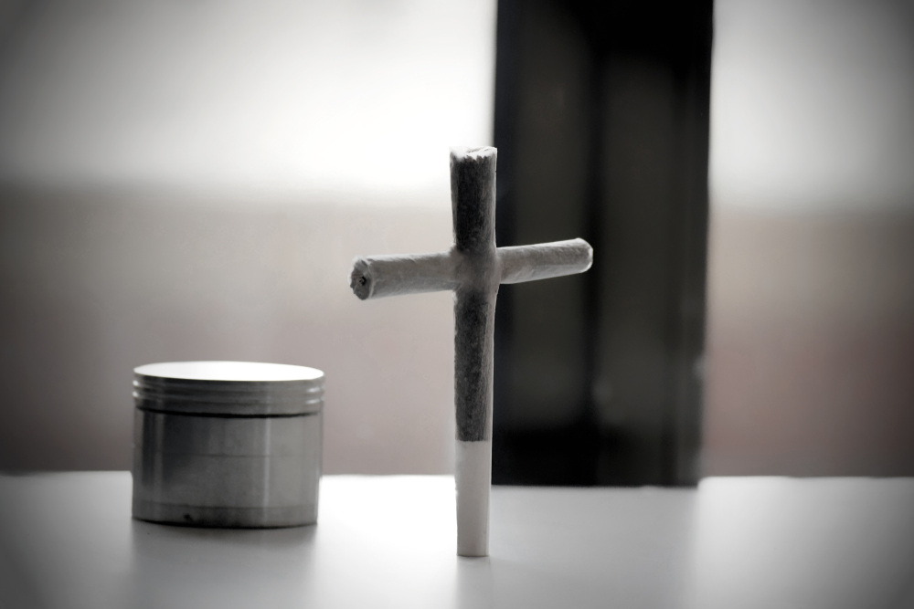 a cross joint next to a grinder on a white table