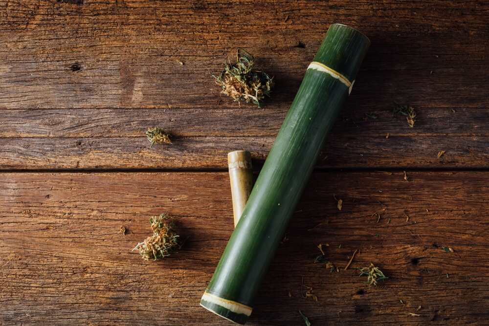 bamboo pipe made to smoke cannabis out of on a wooden table