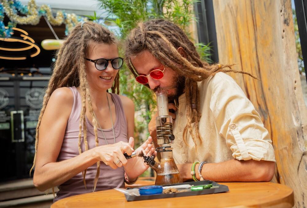 hippie couple smoking from a bong