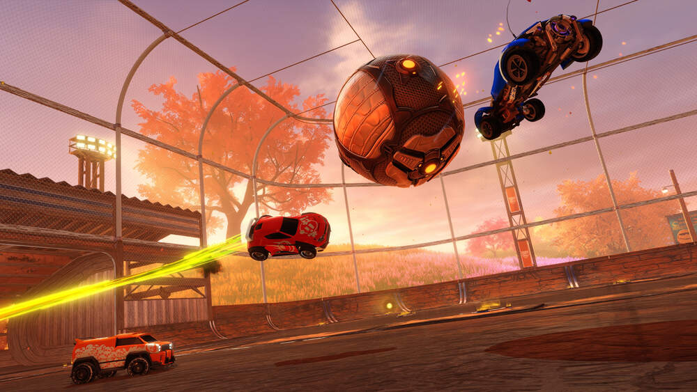 an in-game shot of rocket league with 3 cars and 1 football on a football field with little balls of boost in the background