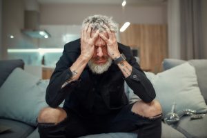 a man holding his head from a weed hangover