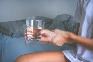 holding glass and getting the weed shakes