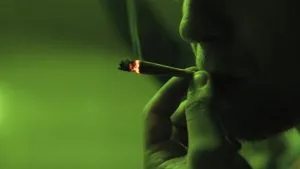 man smoking joint that contains moldy weed